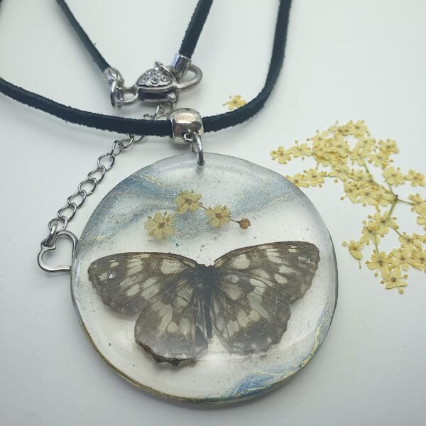 Butterfly with elderflower in resin