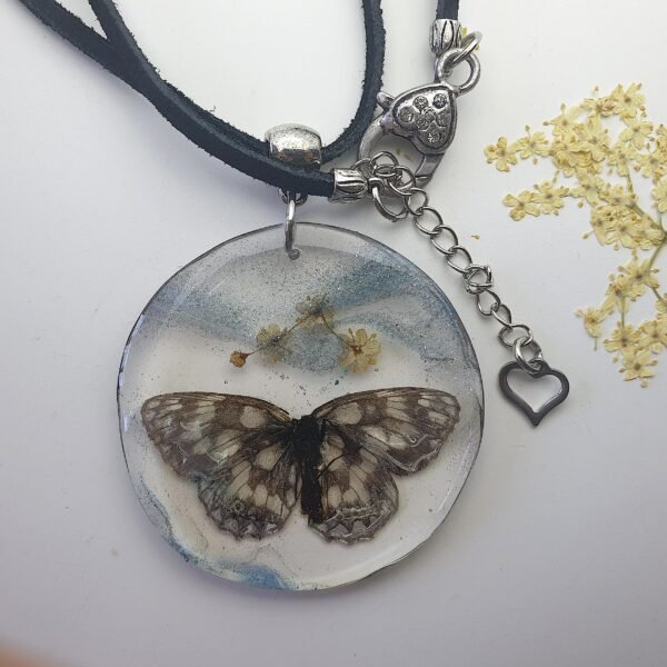 Butterfly with elderflower in resin