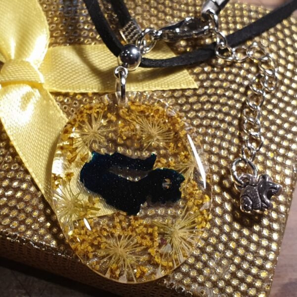 Resin pendant from yellow parsnip flower